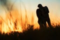 Silhouette of a young couple kissing at sunset Royalty Free Stock Photo