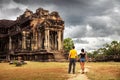 Silhouette young couple in love explores the famous ancient of Khmer architecture style temple Angkor Wat Royalty Free Stock Photo
