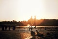 Silhouette of young couple in love are standing on the wooden bridge outdoors near the lake at sunset on summer. Romantic, love, Royalty Free Stock Photo