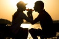 Silhouette of a young couple in love to leave on a picnic out of town drinking wine brotherhood of glass goblets Royalty Free Stock Photo