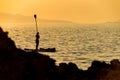 Silhouette of young couple on stand up paddle board. Active vacation, beach life