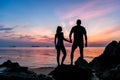 Silhouette young couple standing on the beach holding hands Royalty Free Stock Photo