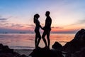 Silhouette young couple standing on the beach holding hands Royalty Free Stock Photo