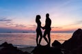 Silhouette young couple standing on the beach holding hands Royalty Free Stock Photo