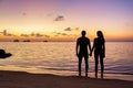 Silhouette young couple standing on the beach holding hands Royalty Free Stock Photo