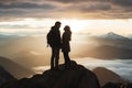 Silhouette of young couple standing on top of a mountain and looking at sunrise, A couple hiking and sharing an intimate moment on