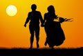 Silhouette of a young couple at sunset. Vector illustration Royalty Free Stock Photo