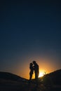 Silhouette of young couple under stars. The concept on the theme of love. romantic evening together, sunset, vertical photo Royalty Free Stock Photo