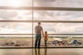 Silhouette of young family, father and daughter on airport terminal Royalty Free Stock Photo