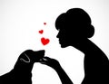 Silhouette of a young female holding cute dog`s Jack Russell Terrier muzzle on her palm. Friendship of a person and a pet. Concep