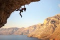 Silhouette of young female rock climber on a cliff Royalty Free Stock Photo