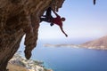 Silhouette of a young female rock climber on a cliff. Royalty Free Stock Photo