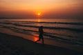 Silhouette young female runner,running at sunset on sea