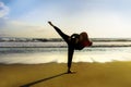 Silhouette of young fit Muslim woman covered in Islam hijab head scarf training martial arts karate kick attack and fitness