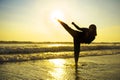 Silhouette of young fit Muslim woman covered in Islam hijab head scarf training martial arts karate kick attack and fitness Royalty Free Stock Photo