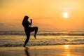 Silhouette of young fit Muslim woman covered in Islam hijab head scarf training martial arts karate kick attack and fitness Royalty Free Stock Photo