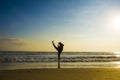 Silhouette of young fit Muslim woman covered in Islam hijab head scarf training martial arts karate kick attack and fitness