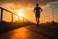 A silhouette of a young fitness enthusiast jogging against a stunning sunrise