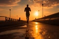 A silhouette of a young fitness enthusiast jogging against a stunning sunrise