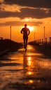 A silhouette of a young fitness enthusiast jogging against a stunning sunrise