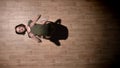 Silhouette of young girl ballerina is dancing on wooden floor, flexure, ballet concept, movement concept, top shot