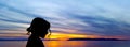 Silhouette of a young girl with sunset over the Adriatic Sea in background - Makarska Royalty Free Stock Photo