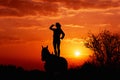 Silhouette of a young girl who is standing on a horse and looks into the distance Royalty Free Stock Photo