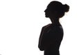 Silhouette of a young graceful woman on a white isolated background, face profile of a beautiful girl