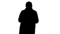 Silhouette Young handsome man in cloak messaging with phone.
