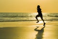 Silhouette of young happy and attractive African American runner woman exercising in running fitness sprint workout at beautiful b Royalty Free Stock Photo