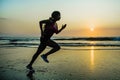 Silhouette of young happy and attractive African American runner woman exercising in running fitness sprint workout at beautiful b Royalty Free Stock Photo