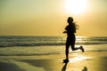 Silhouette of young happy and attractive African American runner woman exercising in running fitness workout at beautiful beach jo Royalty Free Stock Photo