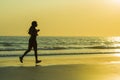 Silhouette of young happy and attractive African American runner woman exercising in running fitness workout at beautiful beach jo Royalty Free Stock Photo