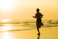 Silhouette of young happy and attractive African American runner woman exercising in running fitness workout at beautiful beach jo Royalty Free Stock Photo