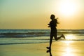 Silhouette of young happy and attractive African American runner woman exercising in running fitness workout at beautiful beach jo Royalty Free Stock Photo