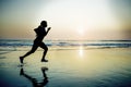 Silhouette of young happy and attractive African American runner woman exercising in running fitness workout at beautiful beach jo Royalty Free Stock Photo