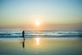 Silhouette of young happy and attractive African American runner woman exercising in running fitness workout at beautiful beach jo Royalty Free Stock Photo