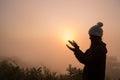 Silhouette of young human hands open palm up worship and praying to god at sunrise, Christian Religion concept background Royalty Free Stock Photo