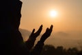 Silhouette of young human hands open palm up worship and praying to god at sunrise, Christian Religion concept background Royalty Free Stock Photo