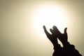 Silhouette of young human hands open palm up worship and praying to god at sunrise, Christian Religion concept background Royalty Free Stock Photo