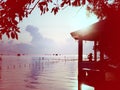 Silhouette of young lady photographer at pavilion beside the sea Royalty Free Stock Photo