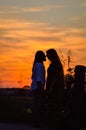 Silhouette of a young loving couple kissing at sunset, in the countryside in autumn Royalty Free Stock Photo