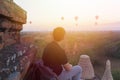 Silhouette of young male backpacker sitting and watching hot air balloon travel destinations in Bagan, Myanmar. Royalty Free Stock Photo