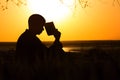 Silhouette of a young man with a Bible, male praying to God in nature, the concept of religion and spirituality Royalty Free Stock Photo