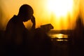 Silhouette of a young man with a Bible, male praying to God in nature, the concept of religion and spirituality Royalty Free Stock Photo