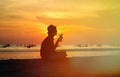 Silhouette of young man drinking cocktail at