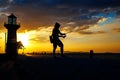 Silhouette of the young man fishing near the beach