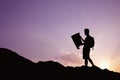 Silhouette of young man looking at a map in nature while hiking Royalty Free Stock Photo