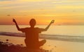 Silhouette of young man meditating at sunset Royalty Free Stock Photo