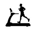 Silhouette of a young man running on a treadmill